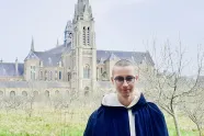 Portrait of Isak Ailu Pulk Eira in front of the Carthusian Order’s monastery, St. Hugh’s Charterhouse.