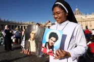 A nun holds a picture of Carlo Acutis and Pier Giorgio Frassati on the day Pope Leo XIV leads a Holy Mass for the canonisation of Carlo Acutis and Pier Giorgio Frassati.
