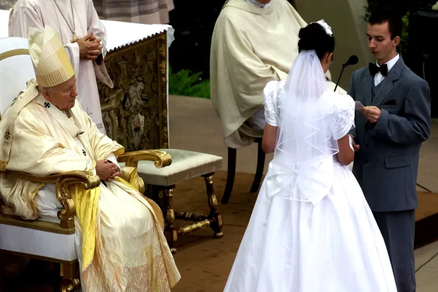 Pave Johannes Paul II sitter foran et ektepar utendørs
